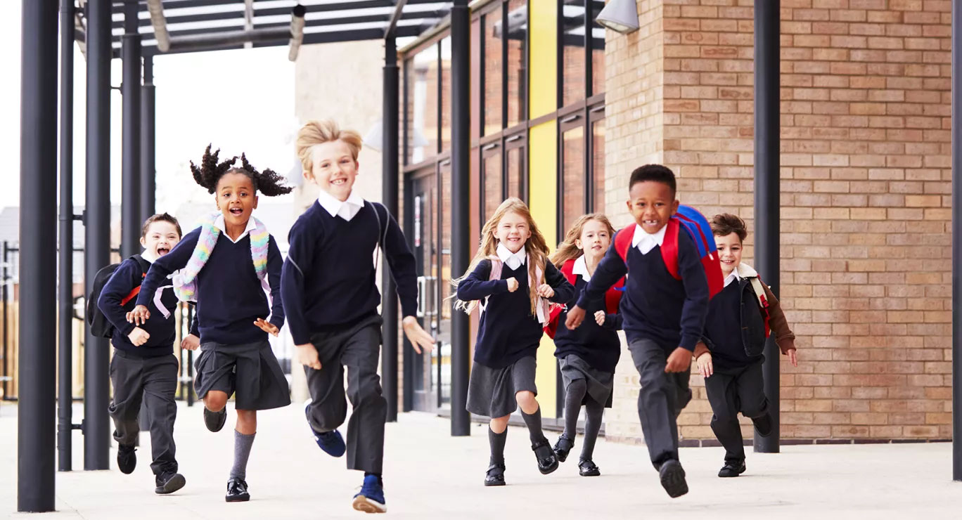 Happy school children running forward
